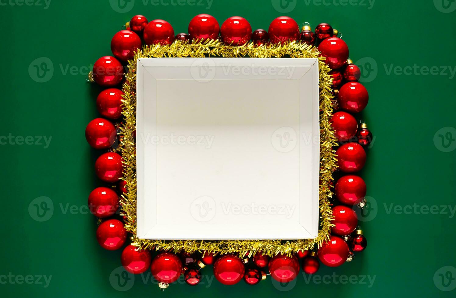 Empty white box with space for text that have red baubles surrounding on green background. Christmas holiday concept. photo
