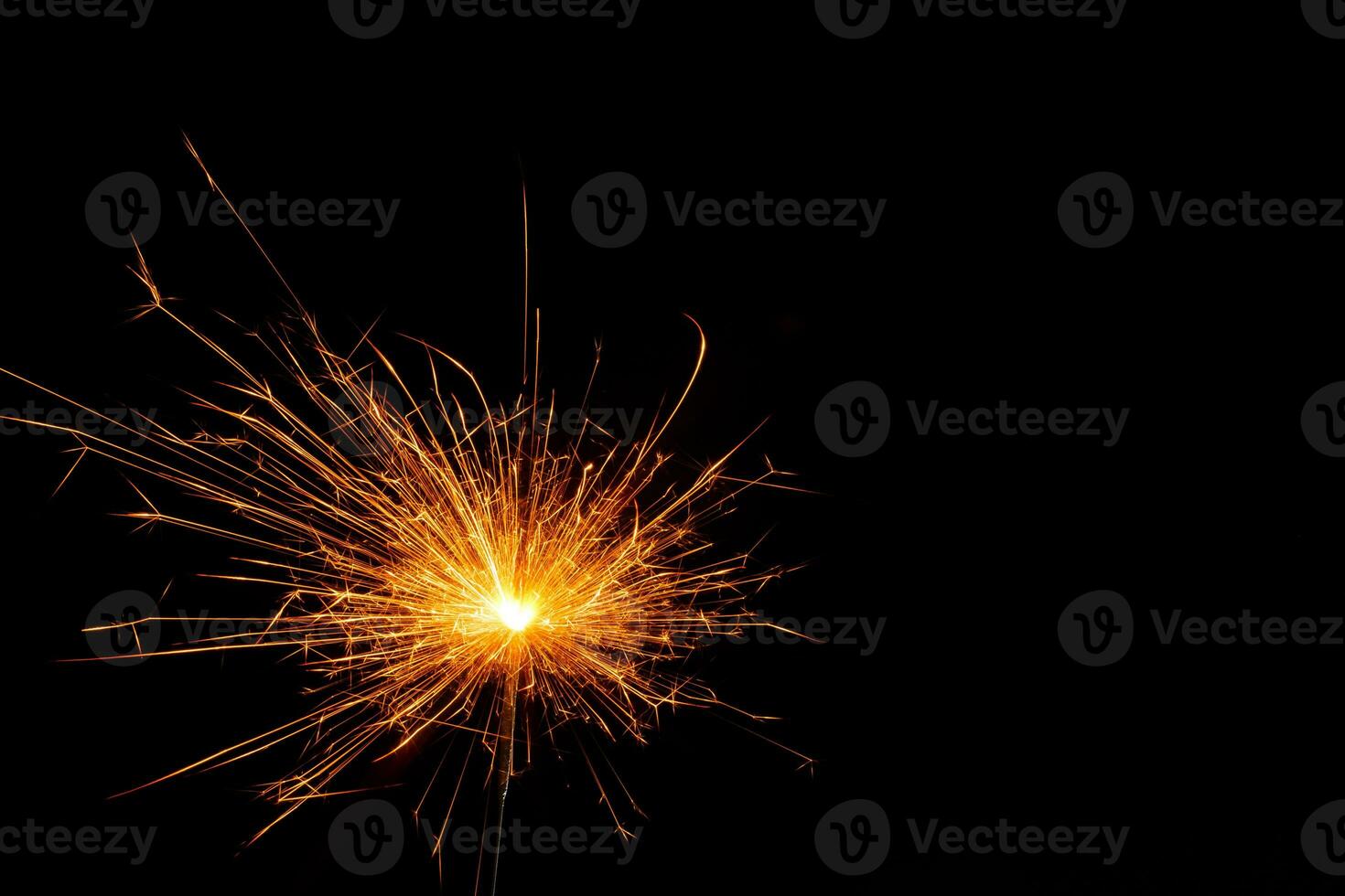 A lit sparkler showing bright sparks photo