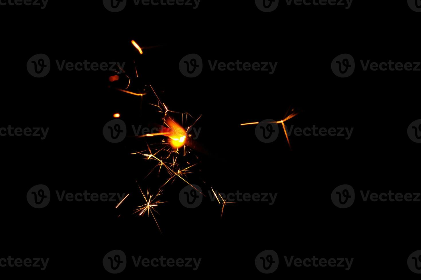 A lit sparkler showing bright sparks photo