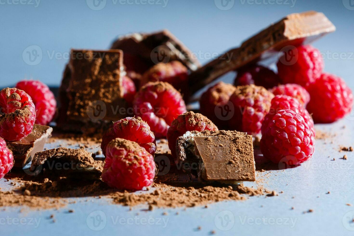 raspberries with chocolate on gray photo