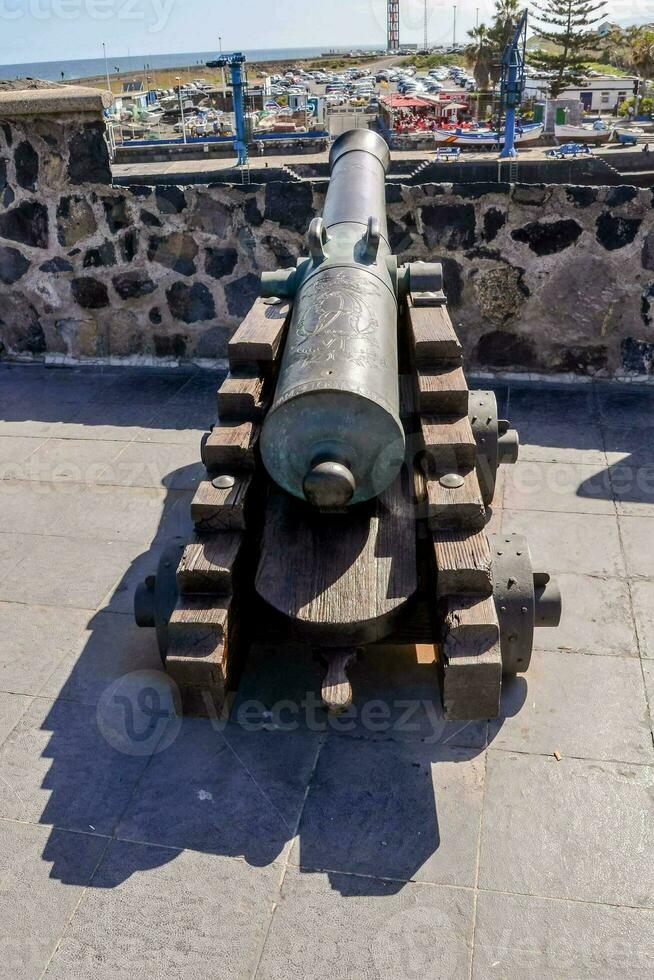 a cannon on the wall of the castle photo