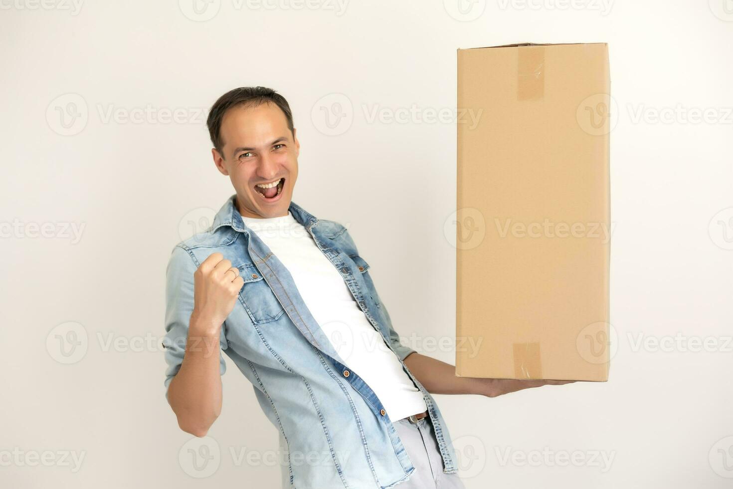 Smiling delivery man giving cardbox on white background photo