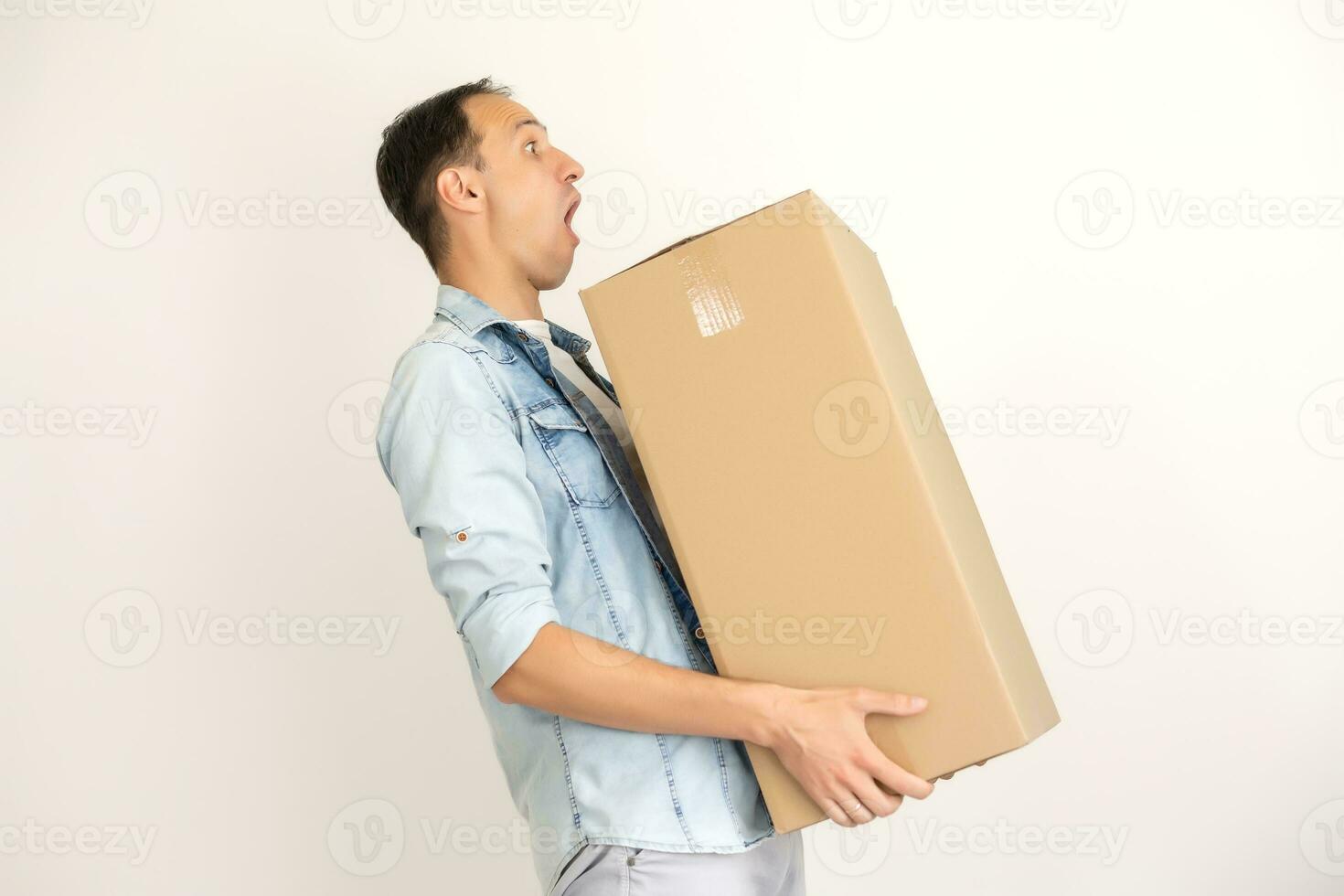 Smiling delivery man giving cardbox on white background photo