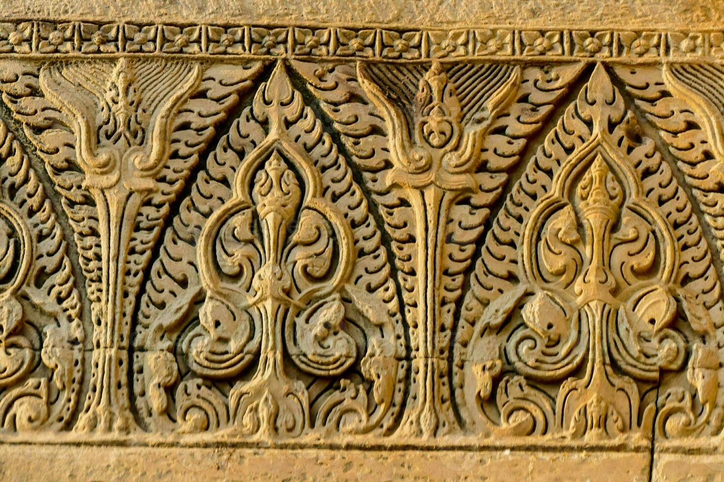 carved stone wall with intricate designs photo