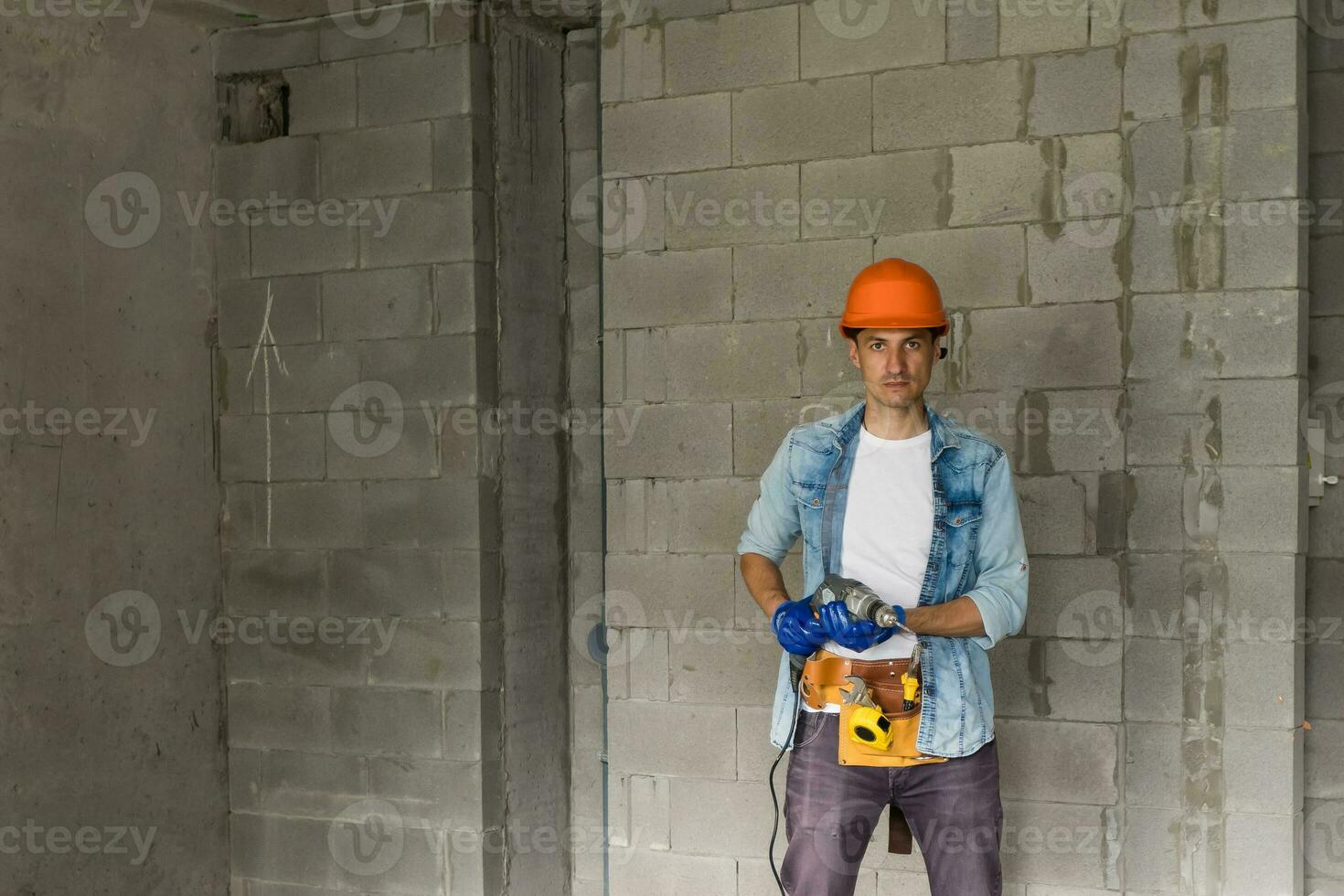 Handyman with a tool belt. House renovation service. photo