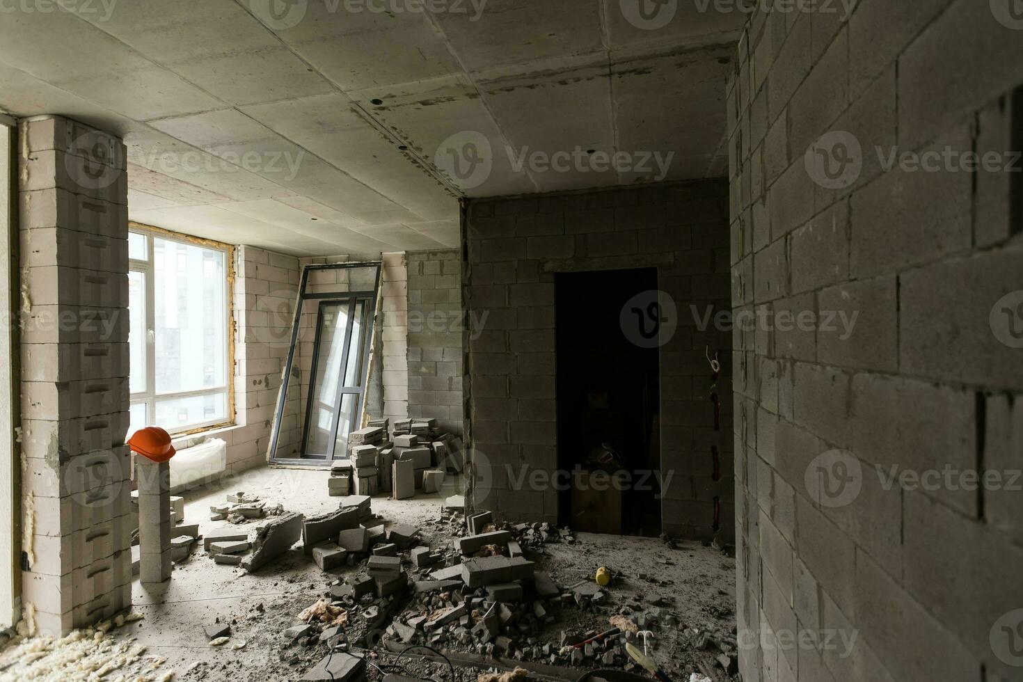 Break the wall for renovation and build the door for entrance of building. Wheelbarrow with broken bricks in site construction. photo