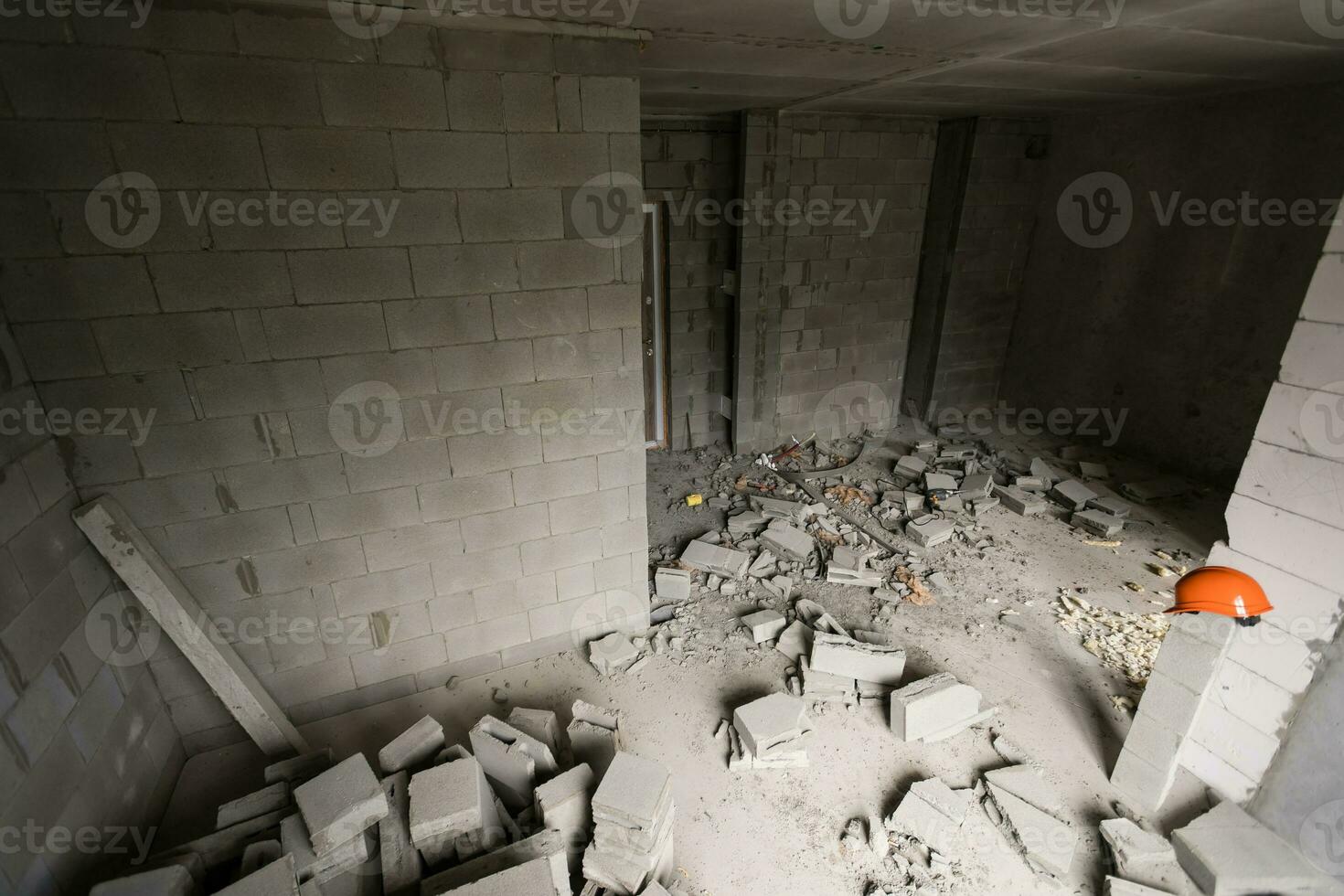 Break the wall for renovation and build the door for entrance of building. Wheelbarrow with broken bricks in site construction. photo