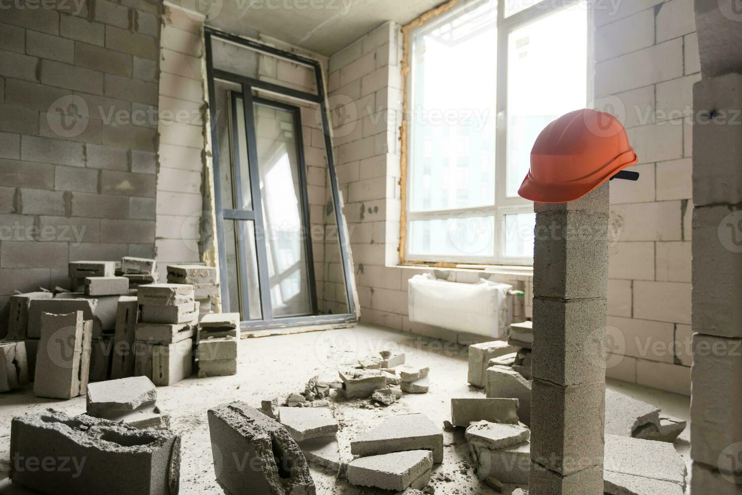 Break the wall for renovation and build the door for entrance of building. Wheelbarrow with broken bricks in site construction. photo
