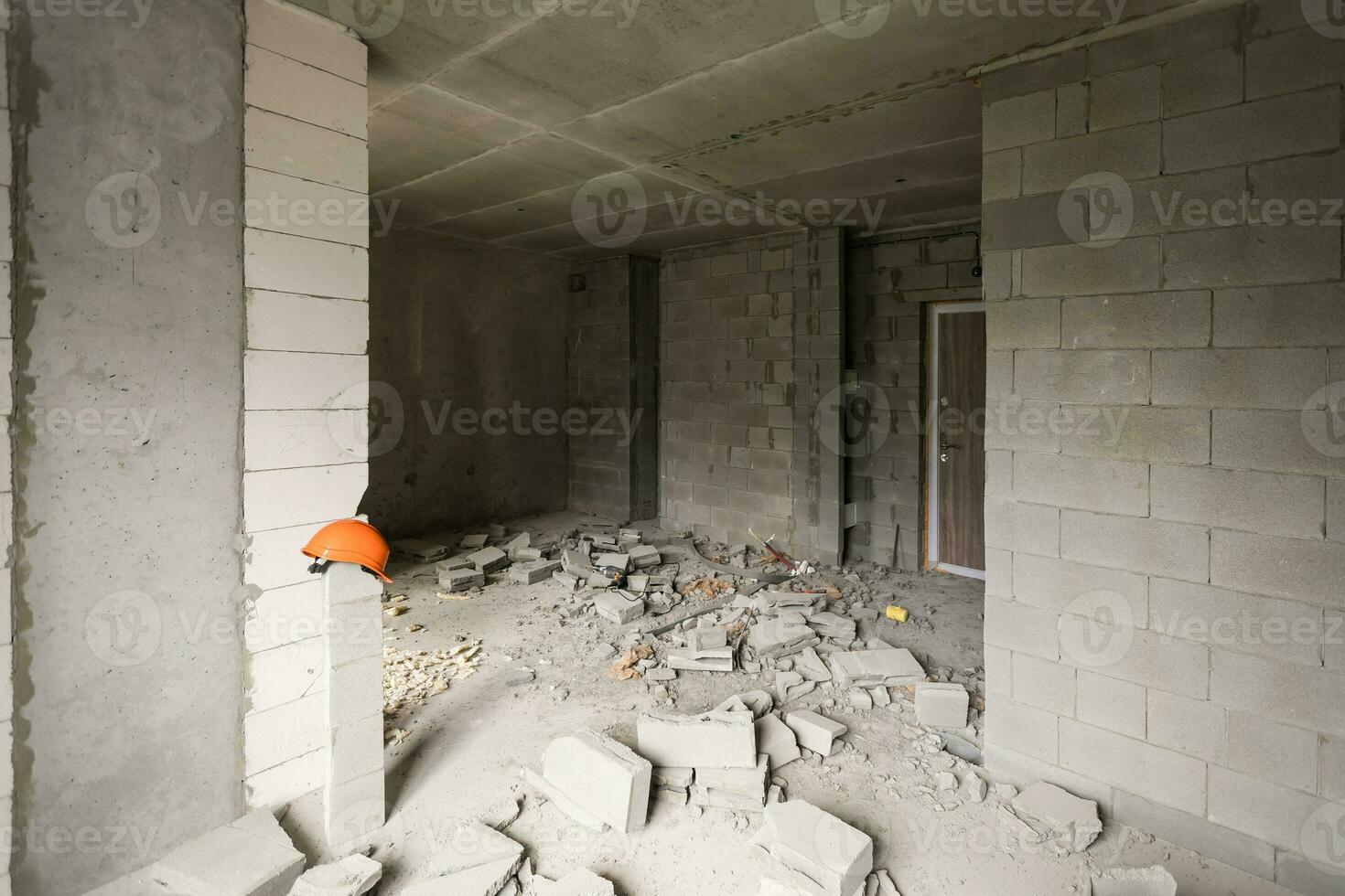 Break the wall for renovation and build the door for entrance of building. Wheelbarrow with broken bricks in site construction. photo