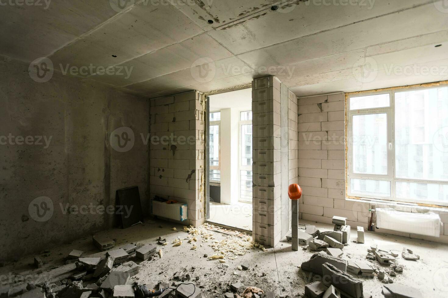 Break the wall for renovation and build the door for entrance of building. Wheelbarrow with broken bricks in site construction. photo