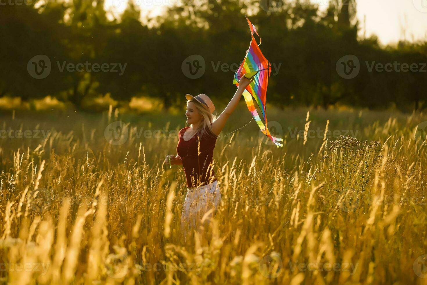 woman with a kite in the field photo