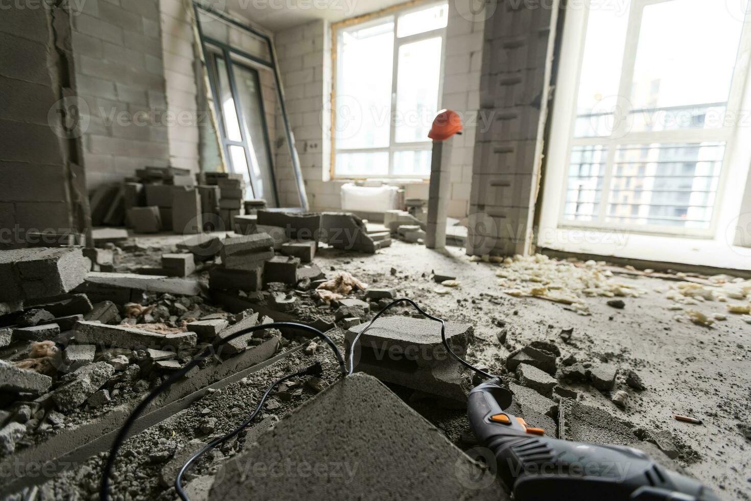 Wall smashed into debris room in apartment ready for renovation with destroyed smashed wall demolish photo