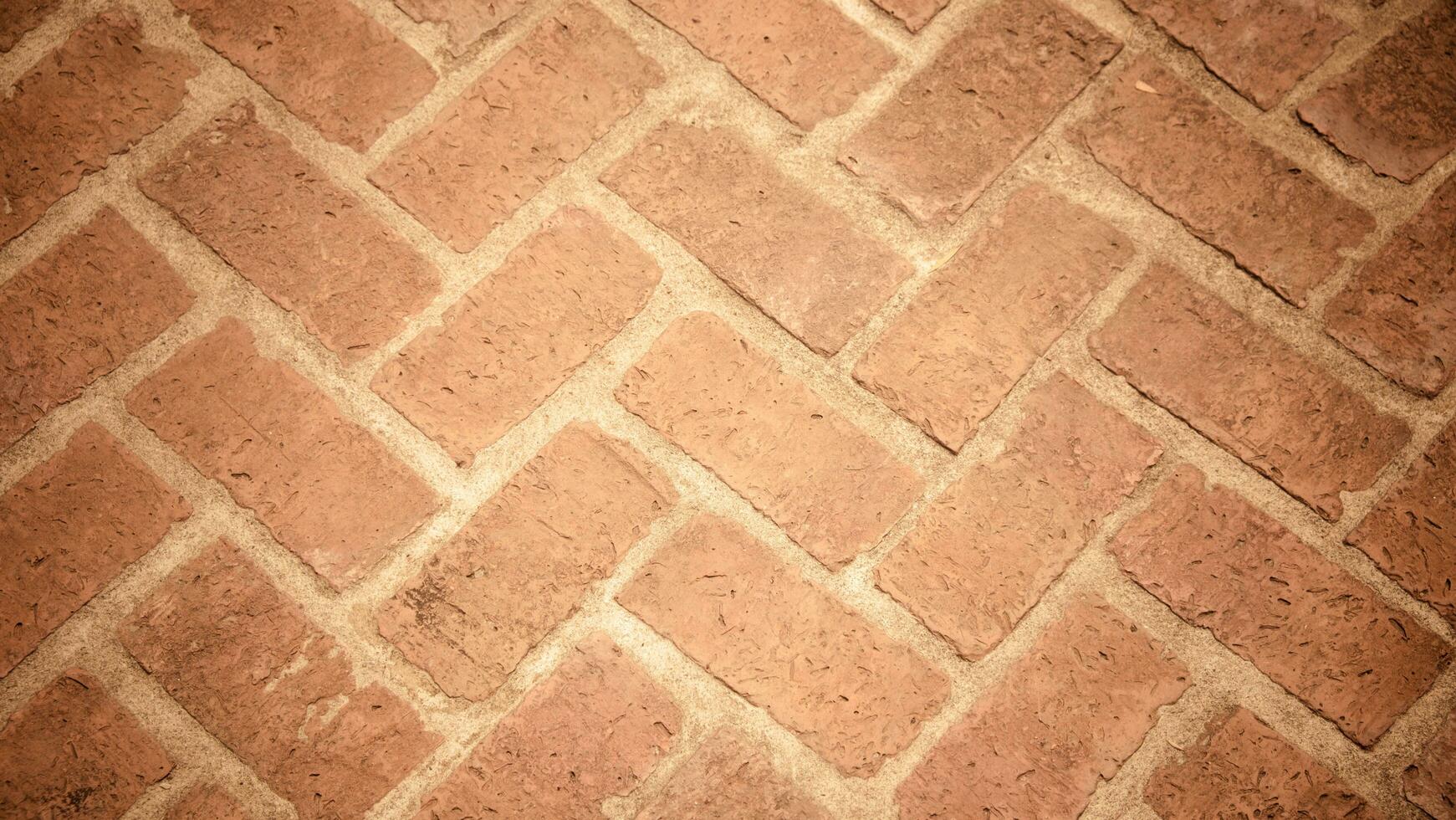 Top view of Reddish-brown brick sidewalk, old, worn, pavement with zigzag patterns. Concept for construction, urban environment improvement, finishing works, landscape design. photo