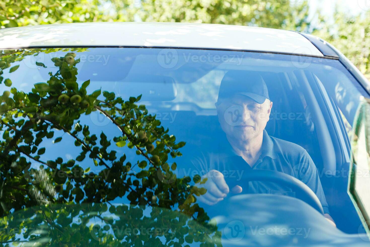 Smiling happy elderly senior man in the new car photo