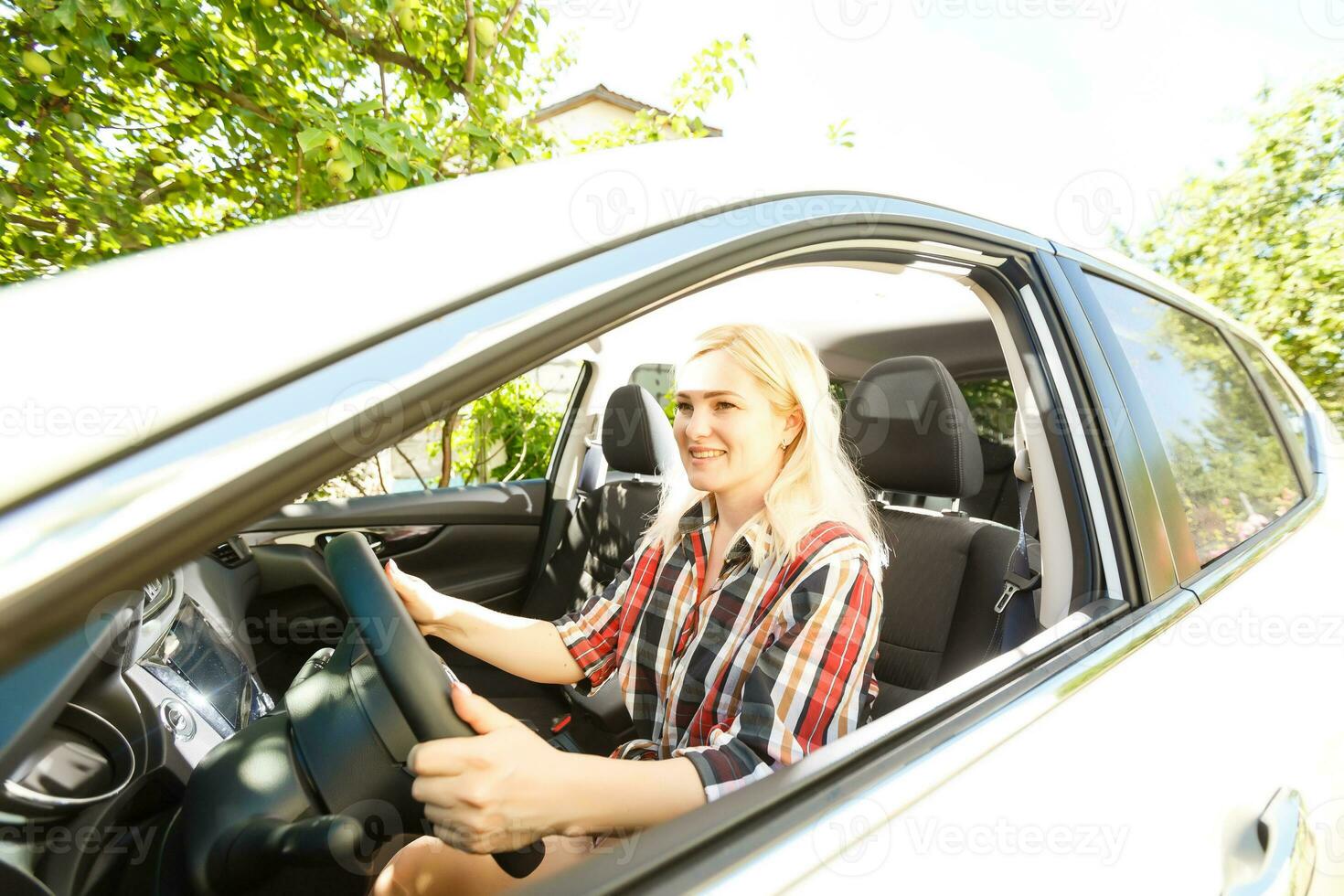 sonriente mujer sentado en coche foto