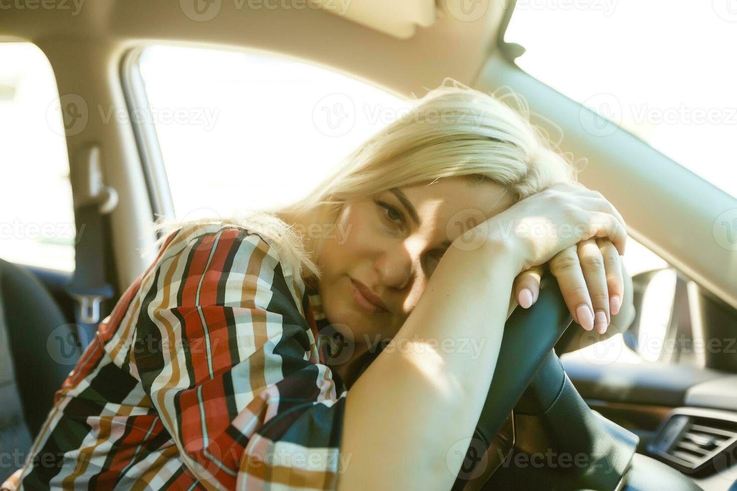 Stressed woman driver sitting inside her car photo