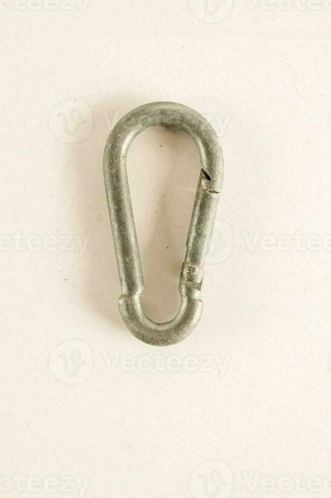 a metal hook on a white surface photo