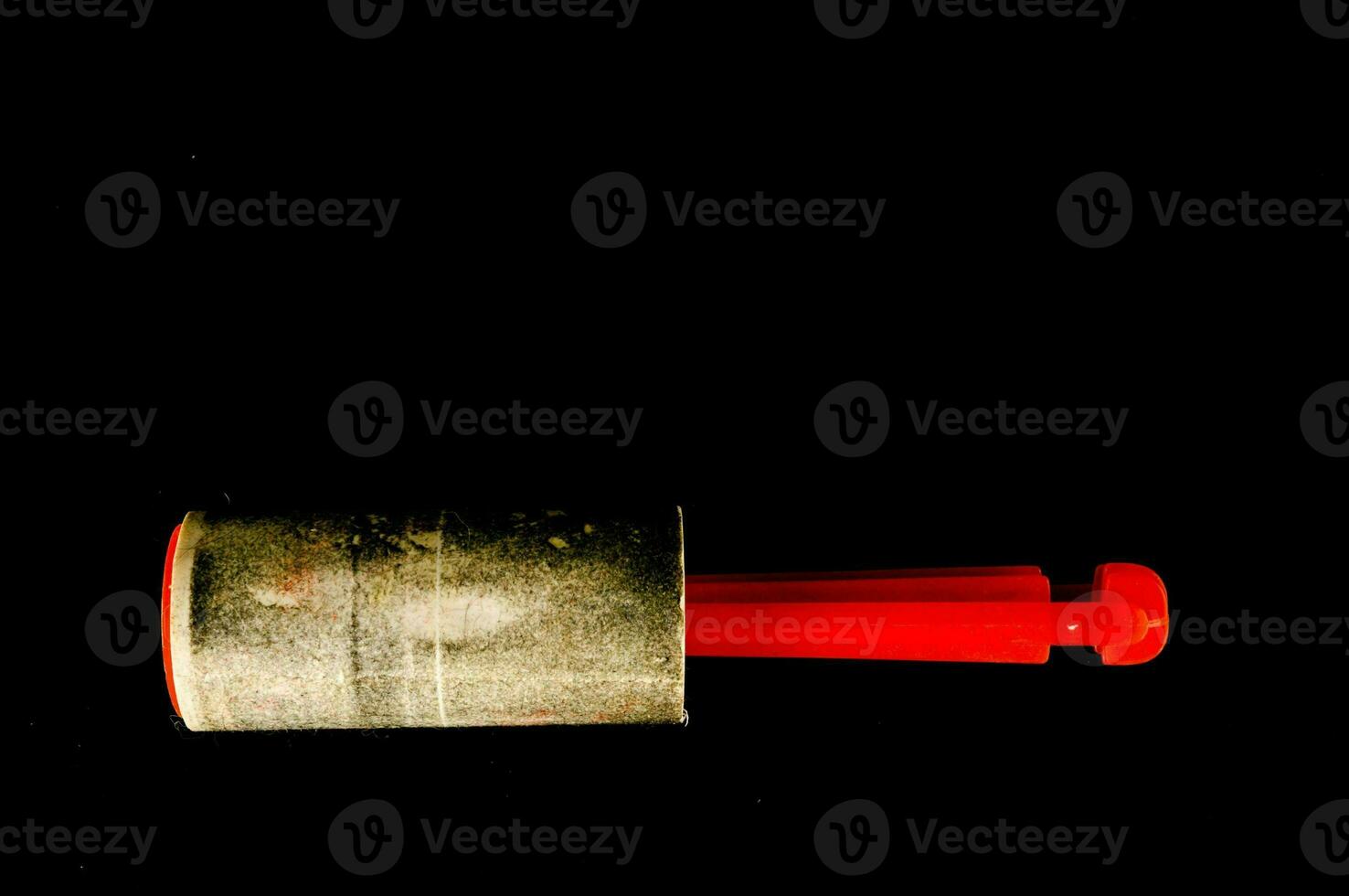 a white tube with a red handle photo