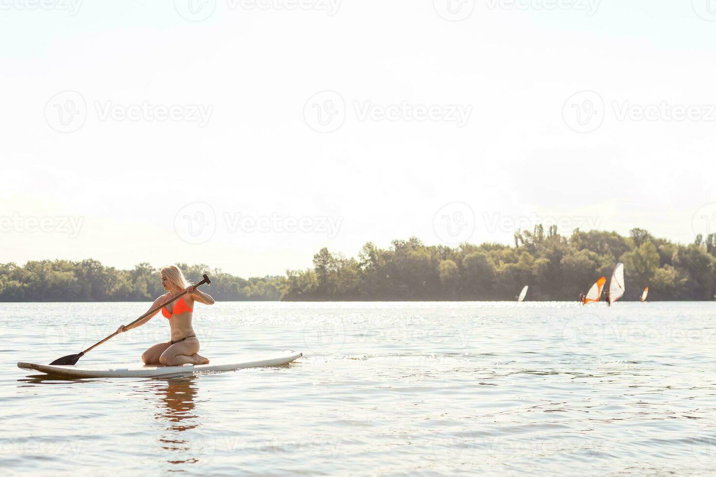 Action Shot of Young Woman on Paddle Board photo