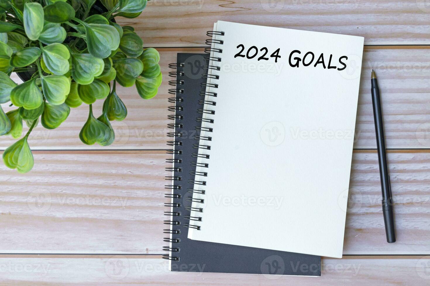 2024 goals written on notebook on office desk table. Business concept. photo