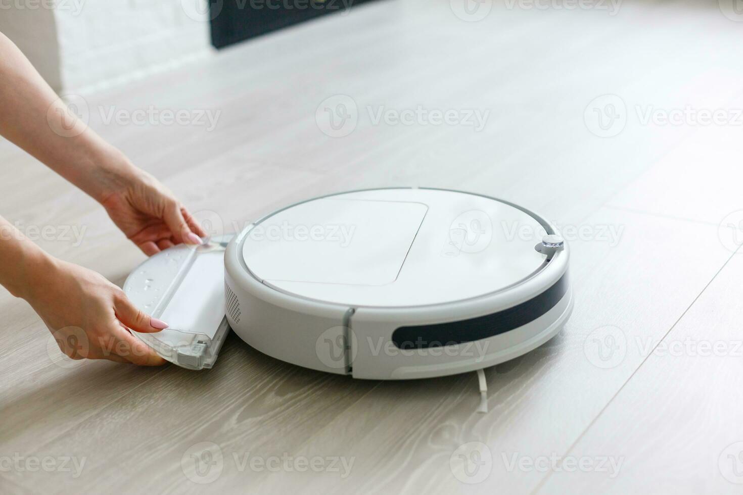 Robotic vacuum cleaner. Container with garbage from a smart robot vacuum cleaner. housework and technology concept photo