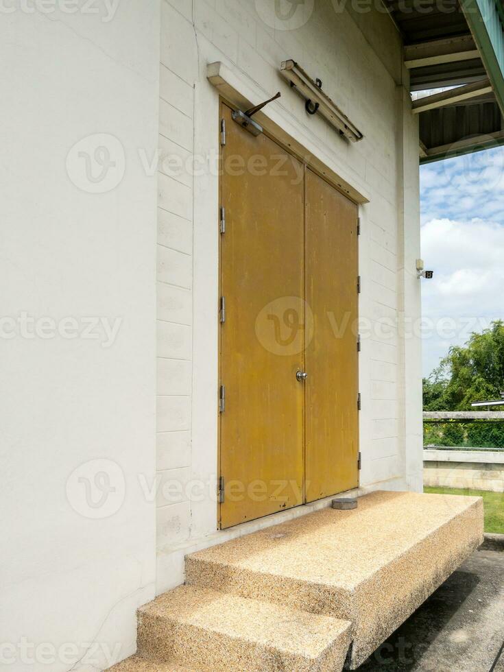 The yellow metal door with the door closes. photo