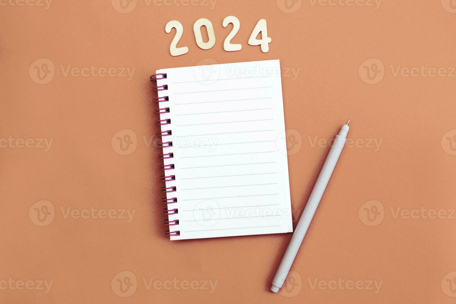 Top view of white paper blank notebook for writing wish list. photo