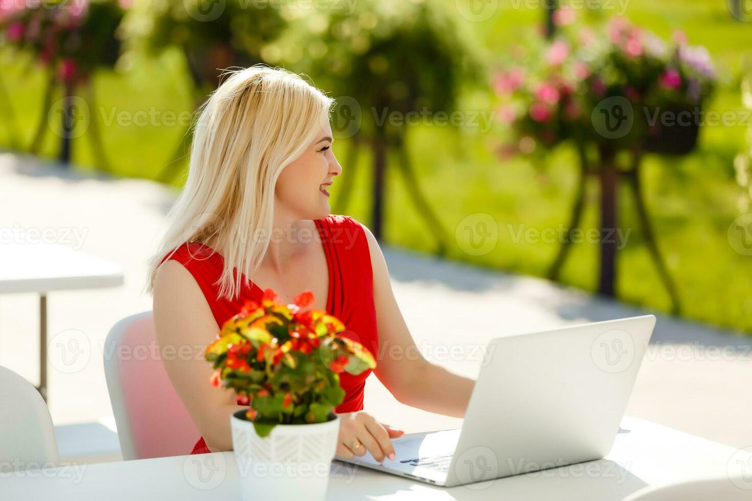 Portrait of a woman buying online or booking hotel with a laptop and credit card on the beach in vacations. E commerce concept photo