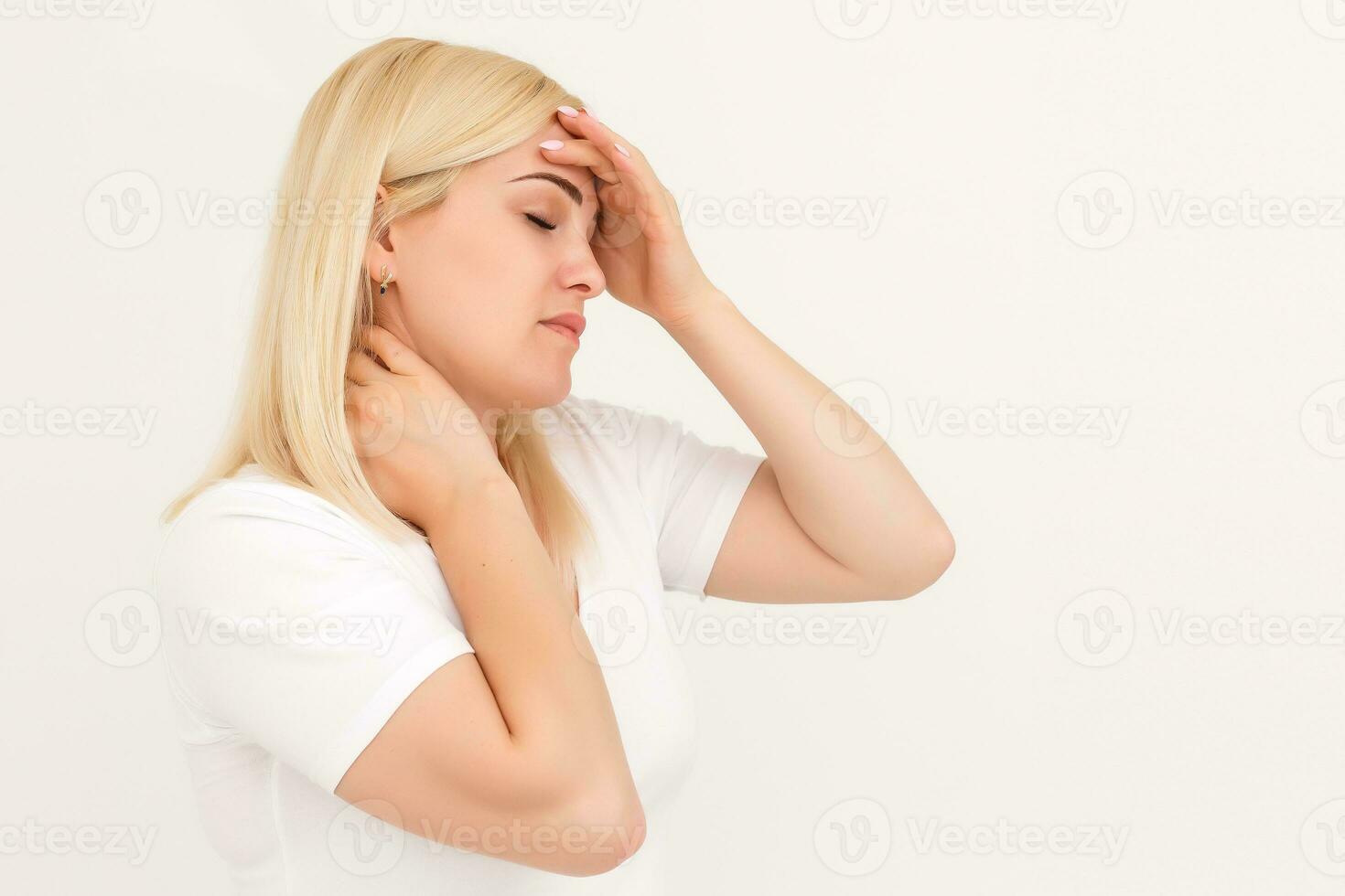 Portrait of stressed beautiful woman walking on the street and holding her head with hands trying to remember something or having headache. photo