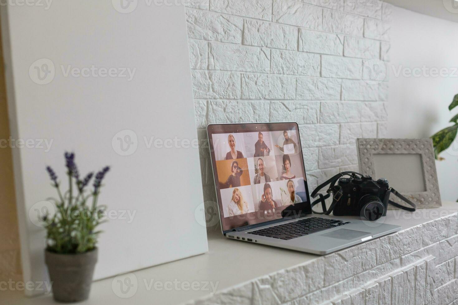 Business Person Videoconferencing With Colleagues On Laptop photo