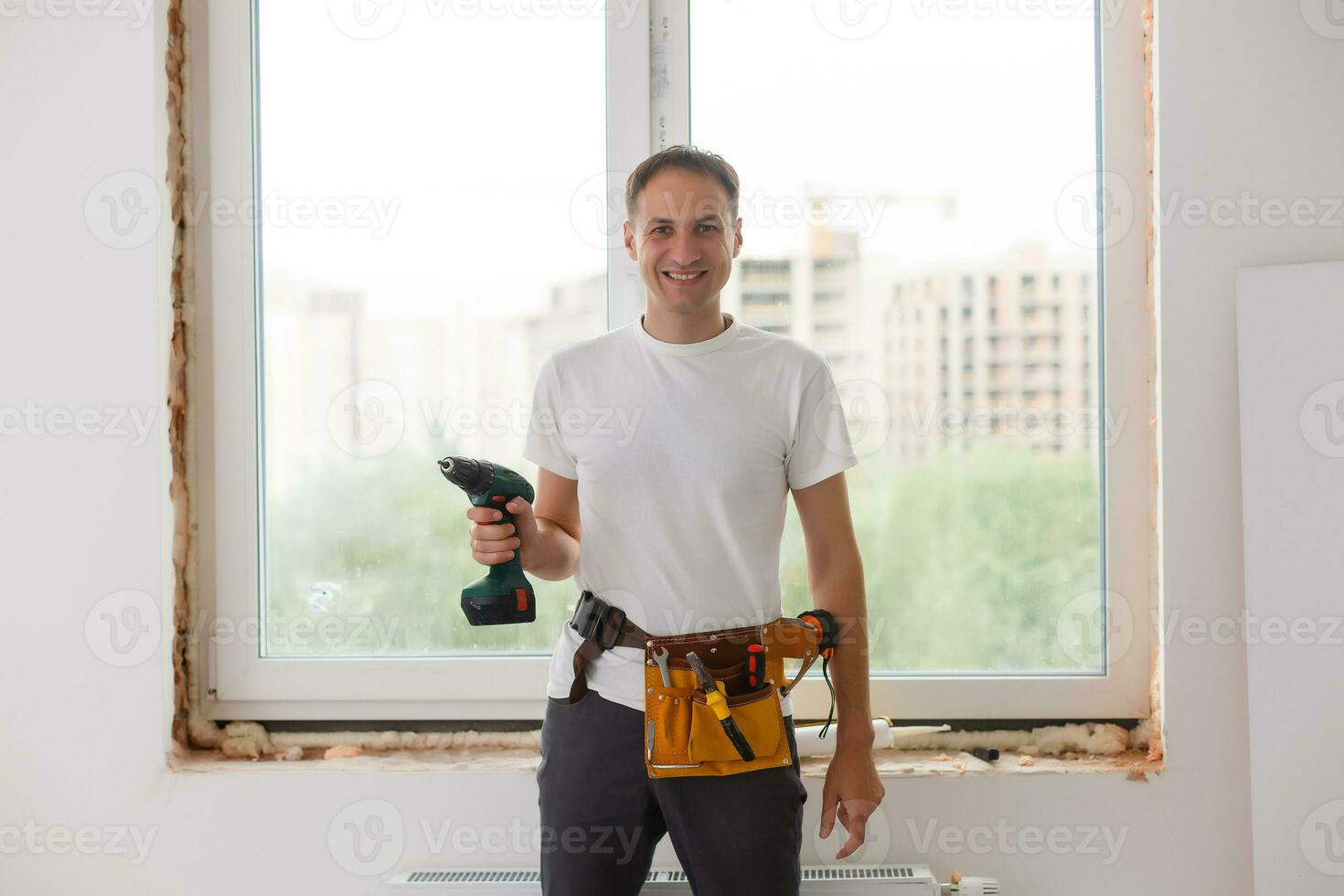 Young handyman repair window with screwdriver photo