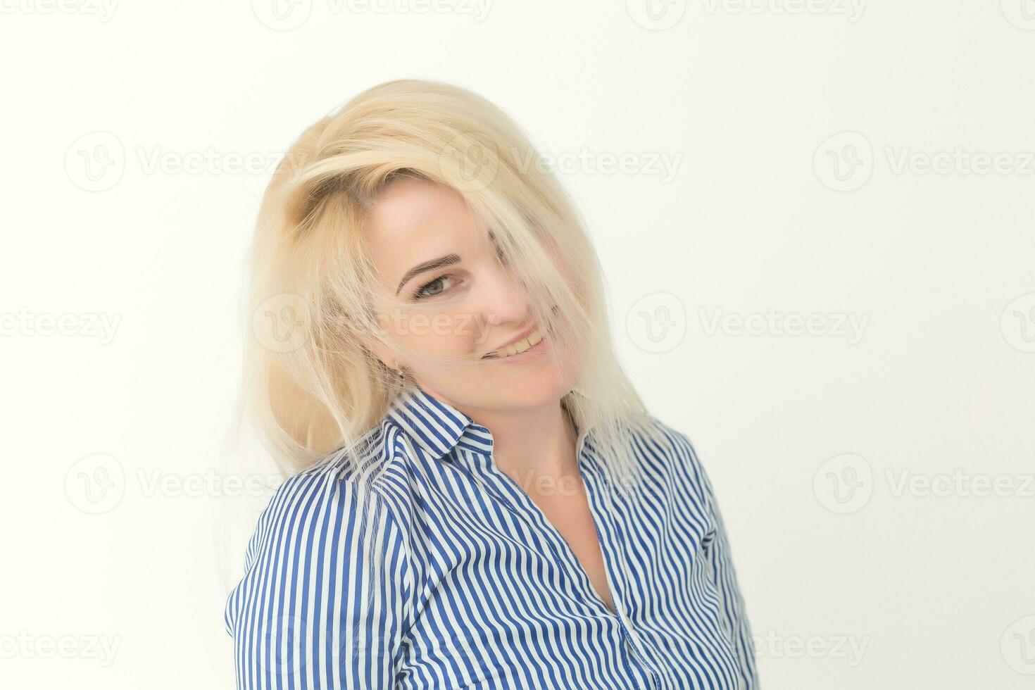 Portrait of emotive good-looking caucasian woman laughing while looking aside and standing against white background. photo