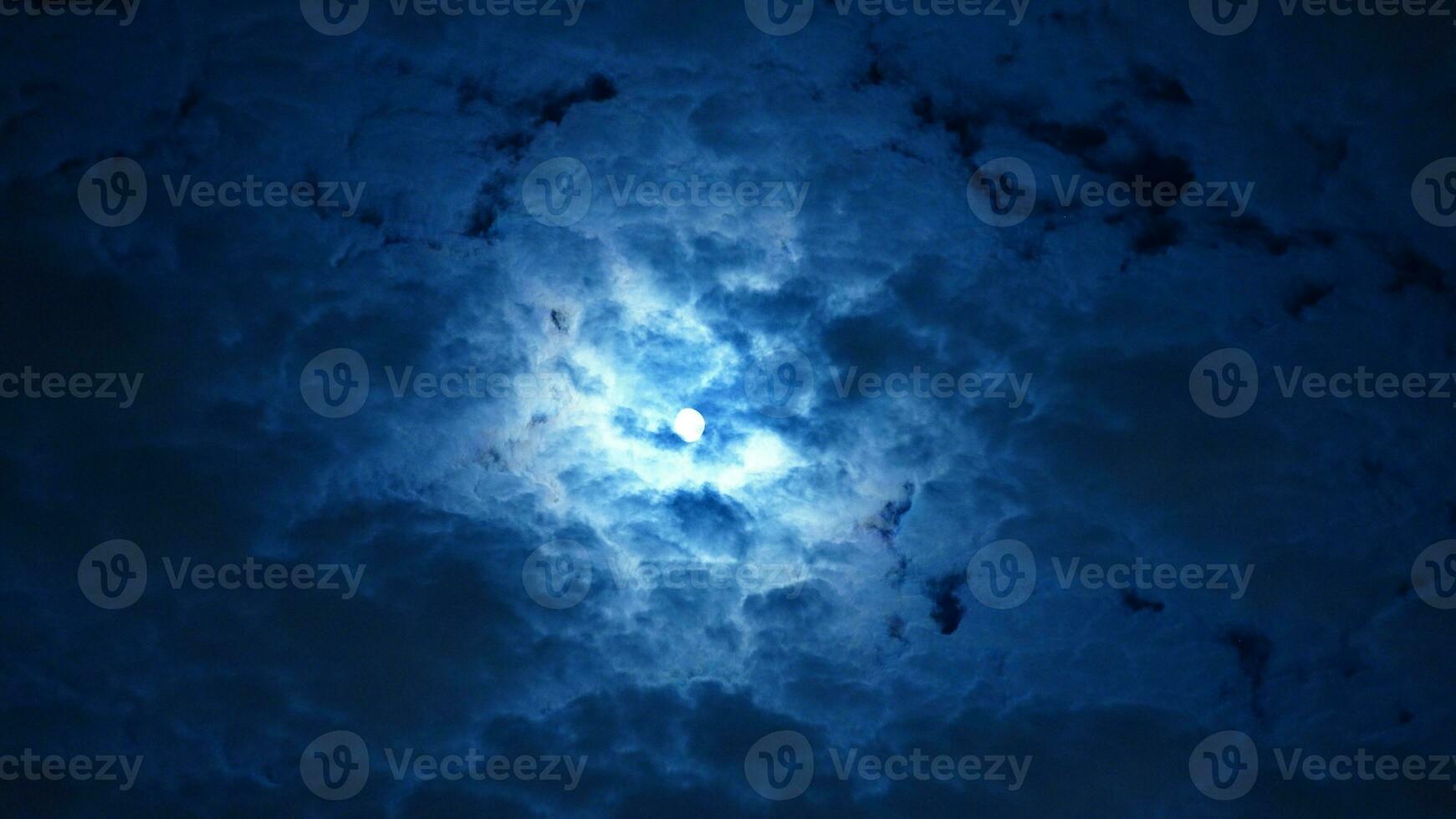 The moon night view with the full moon and clouds in the sky photo