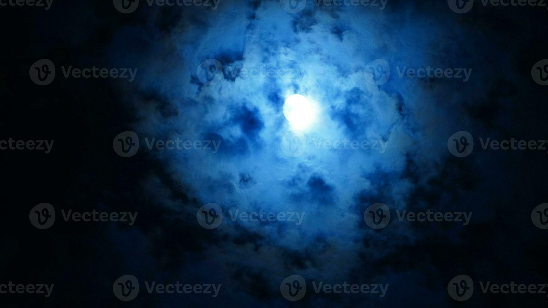 The moon night view with the full moon and clouds in the sky photo