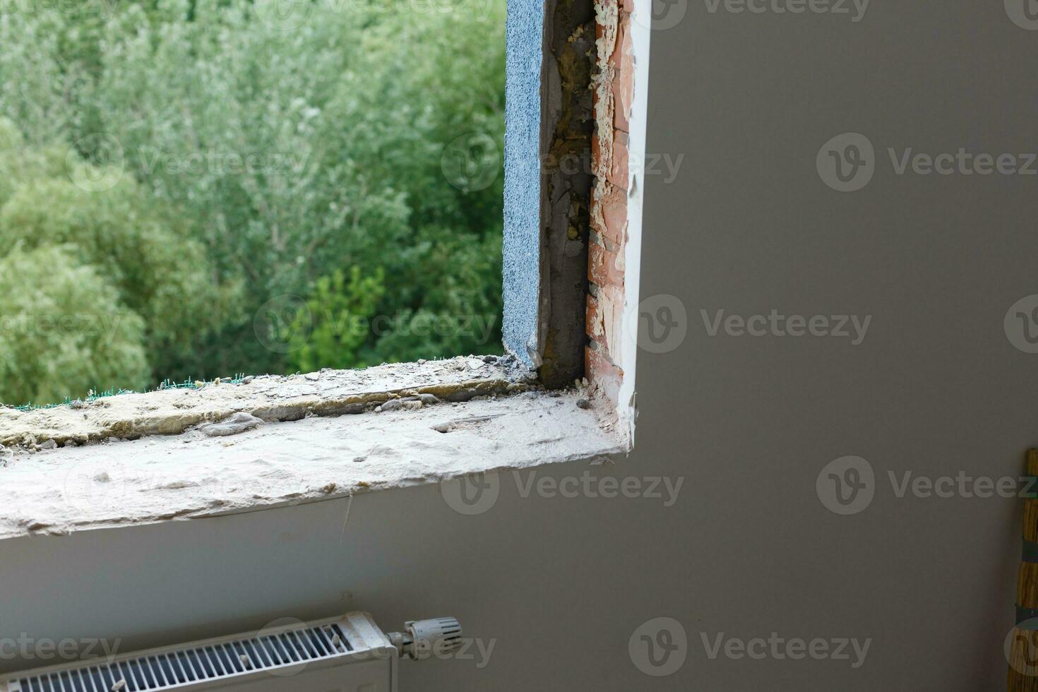 Empty frame on a wide panoramic window. Gorgeous view from the window of an apartment in a multi-storey building. Roofs of houses and trees from a height. Beautiful view through the window. Frame for photo