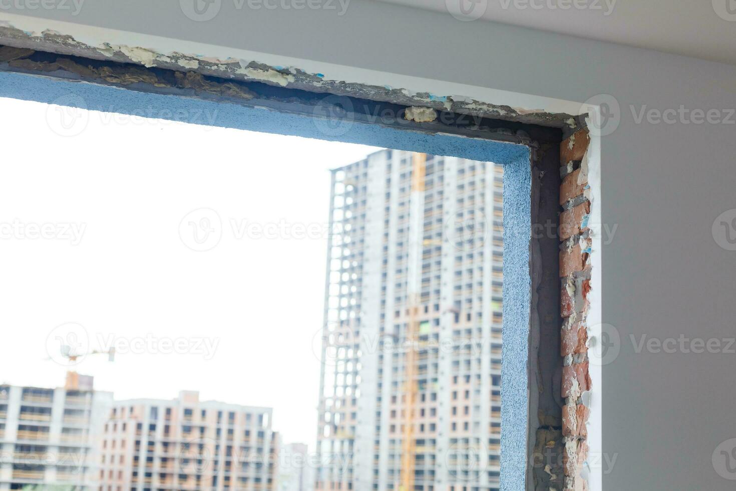 Empty frame on a wide panoramic window. Gorgeous view from the window of an apartment in a multi-storey building. Roofs of houses and trees from a height. Beautiful view through the window. Frame for photo