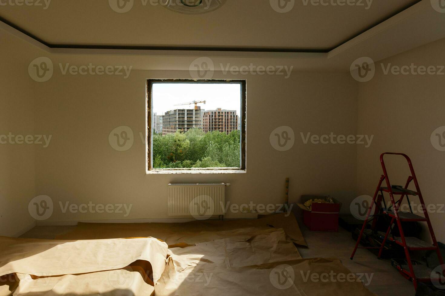 Empty frame on a wide panoramic window. Gorgeous view from the window of an apartment in a multi-storey building. Roofs of houses and trees from a height. Beautiful view through the window. Frame for photo