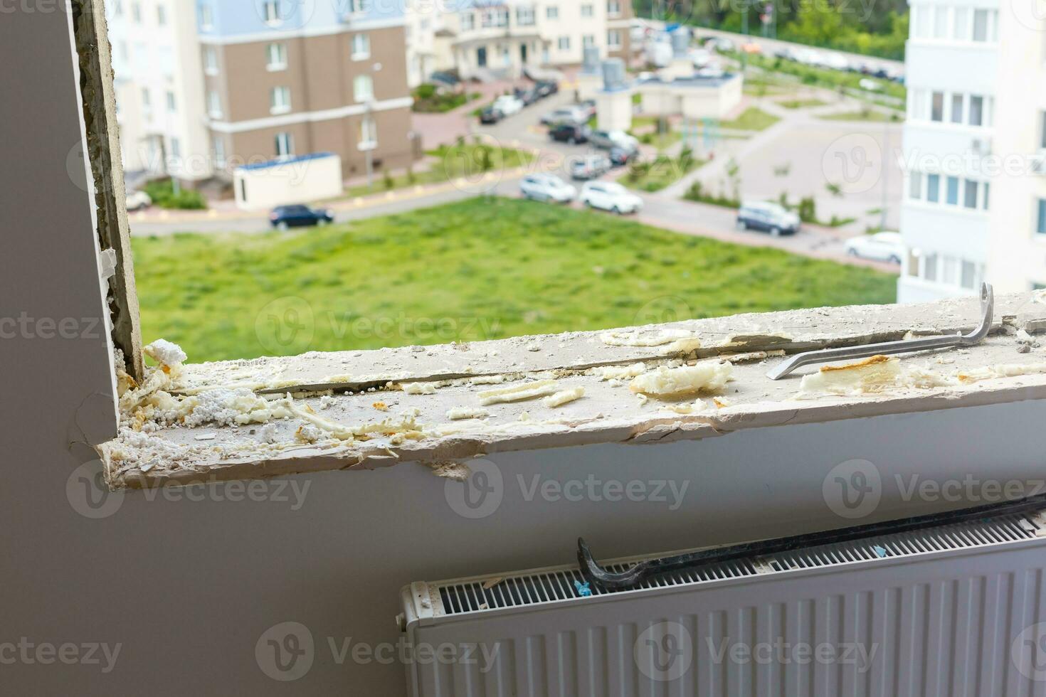 Empty frame on a wide panoramic window. Gorgeous view from the window of an apartment in a multi-storey building. Roofs of houses and trees from a height. Beautiful view through the window. Frame for photo