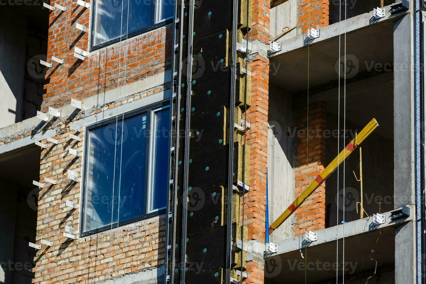 Thermal insulation of a house wall on a building site photo