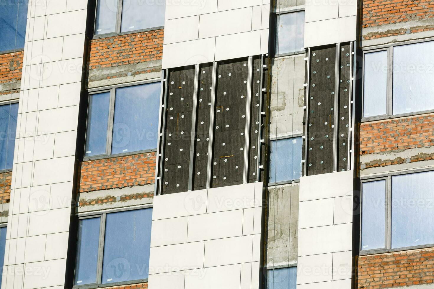 Thermal insulation of a house wall on a building site photo