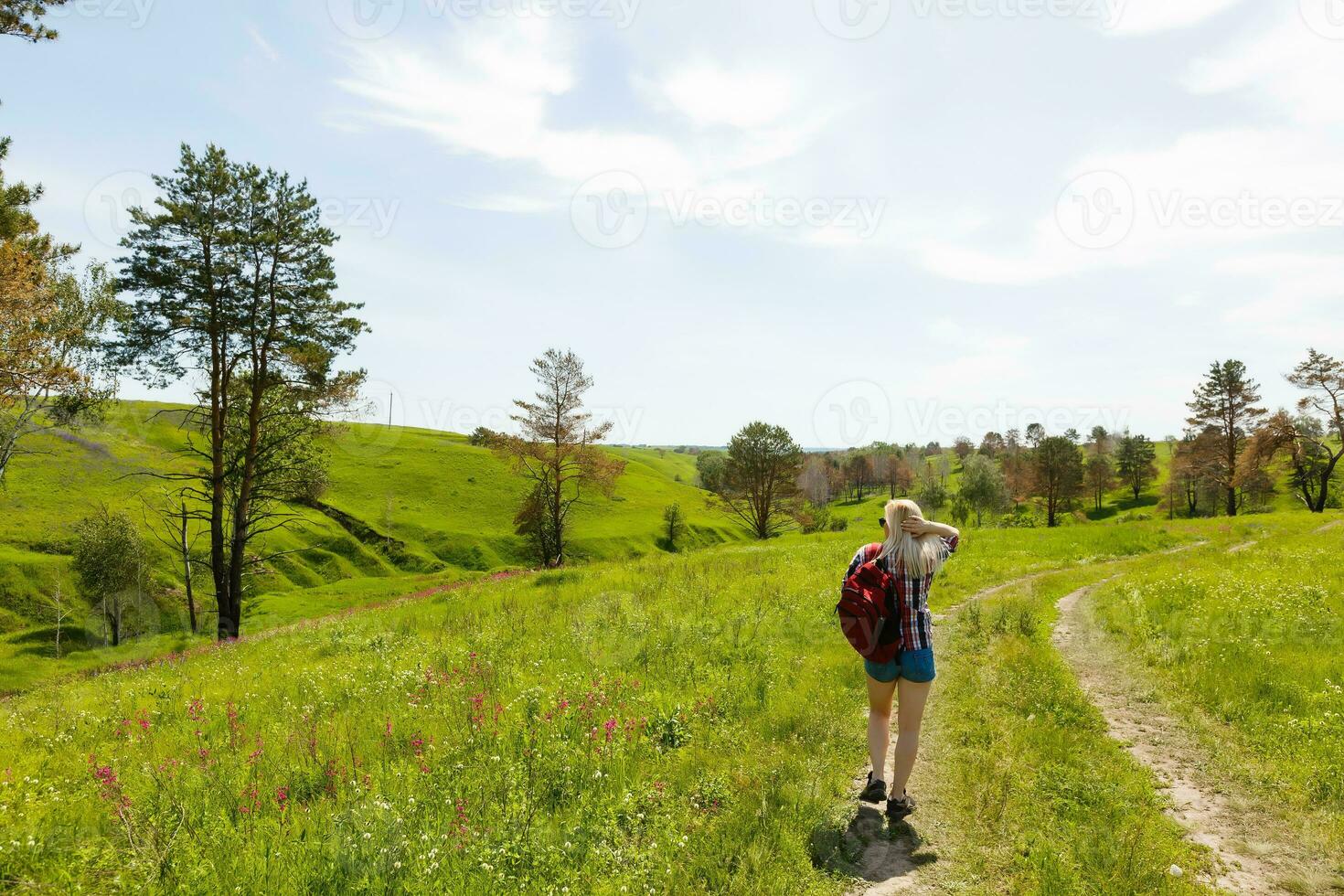 Lifestyle summer image of pretty blonde hipster woman with bag pack traveling and enjoying, stylish fresh look, happy mood, sunny colors, travel concept, emotions. photo