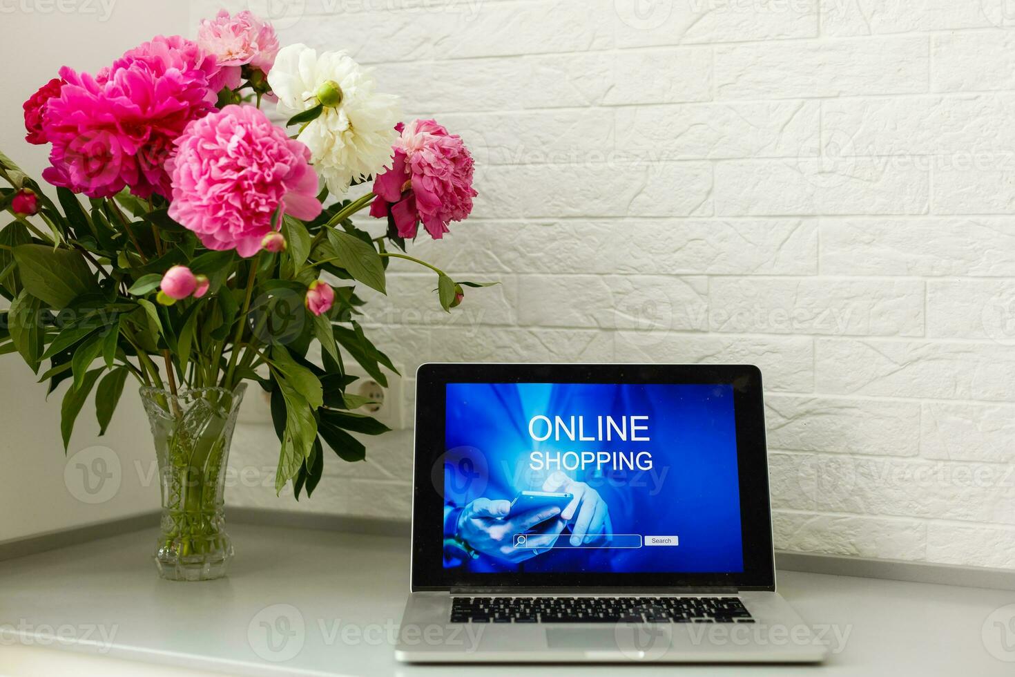 woman holding laptop for online shopping photo