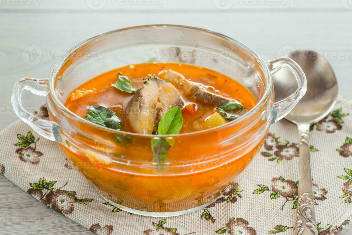 vegetable tomato soup with fish in a plate photo