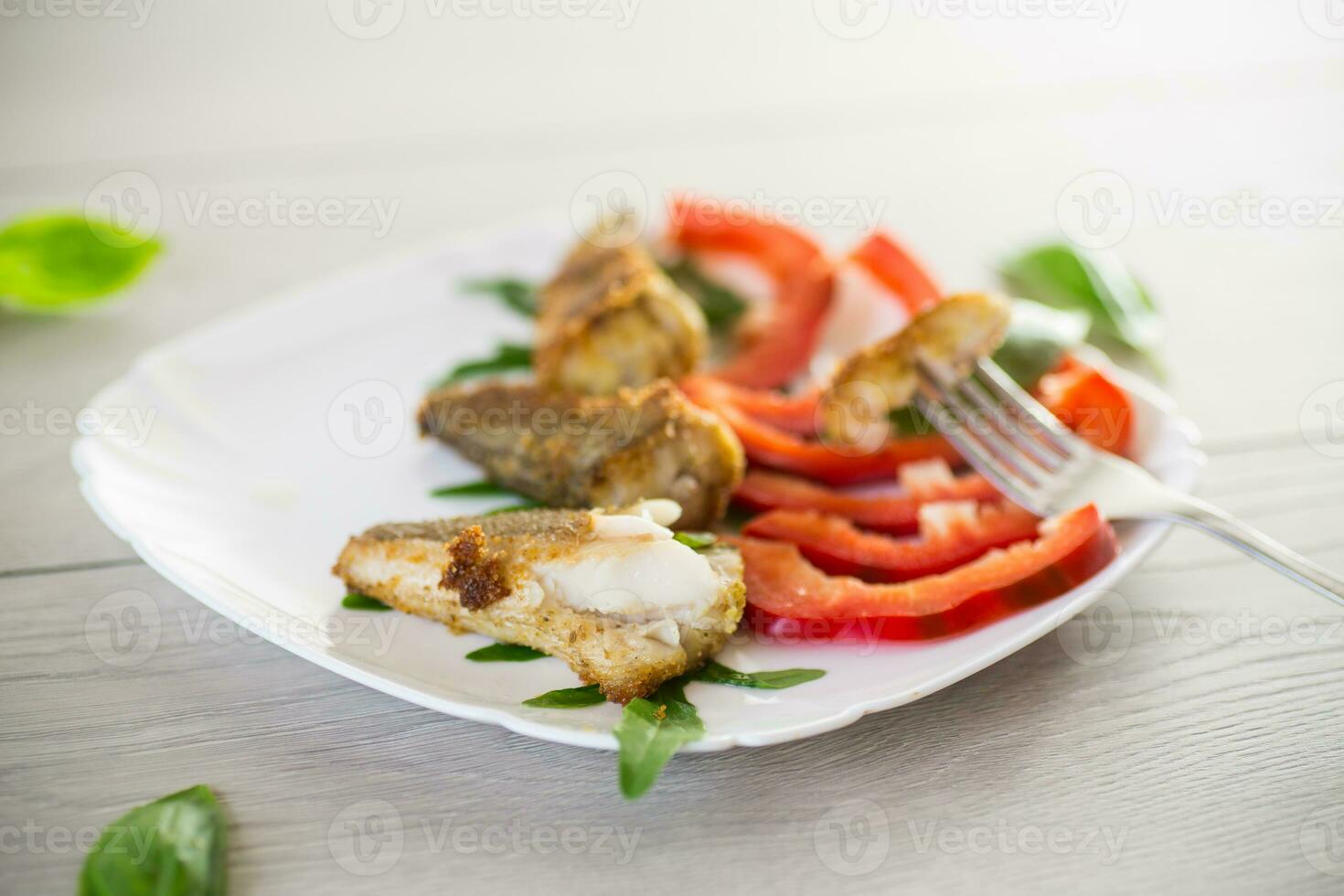 Pieces of fried hake fish in a plate with pepper photo