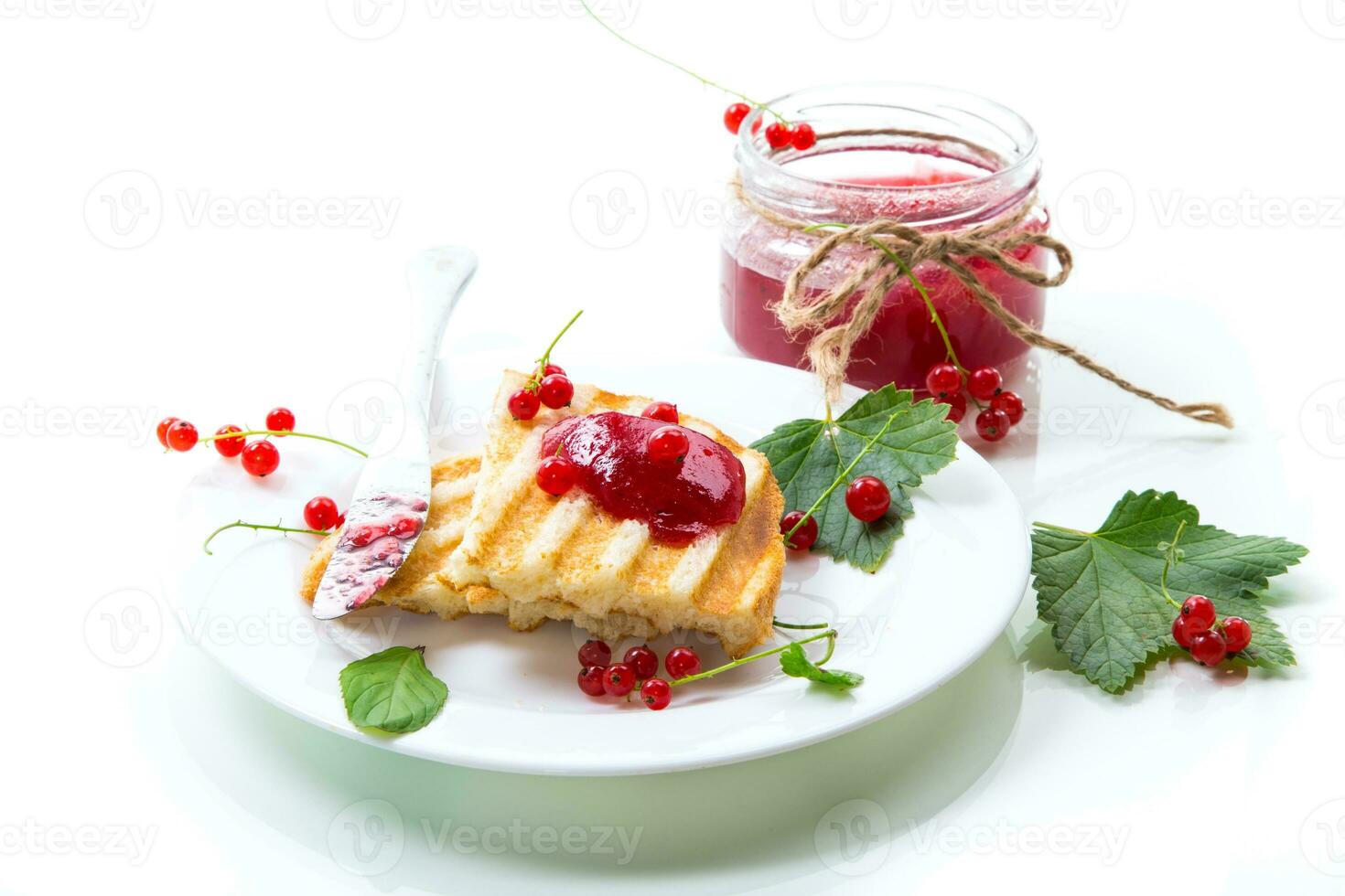 fried bread croutons for breakfast with redcurrant jam in a plate with berries photo
