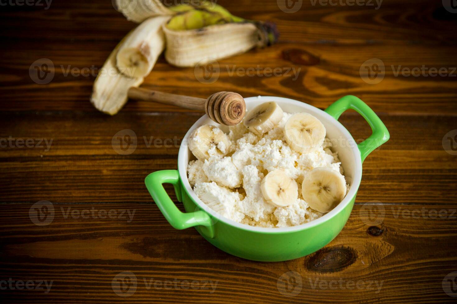 homemade cottage cheese in a bowl with bananas and honey photo