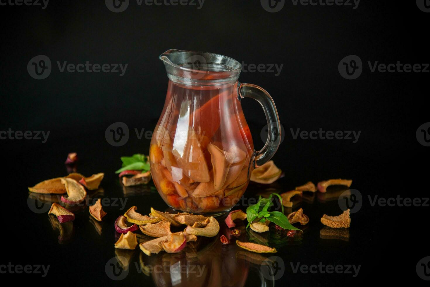 sweet cool compote boiled from various dried fruits, in a glass decanter photo
