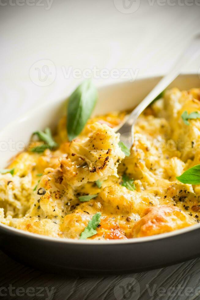 baked cauliflower with vegetables and cheese and scrambled eggs photo