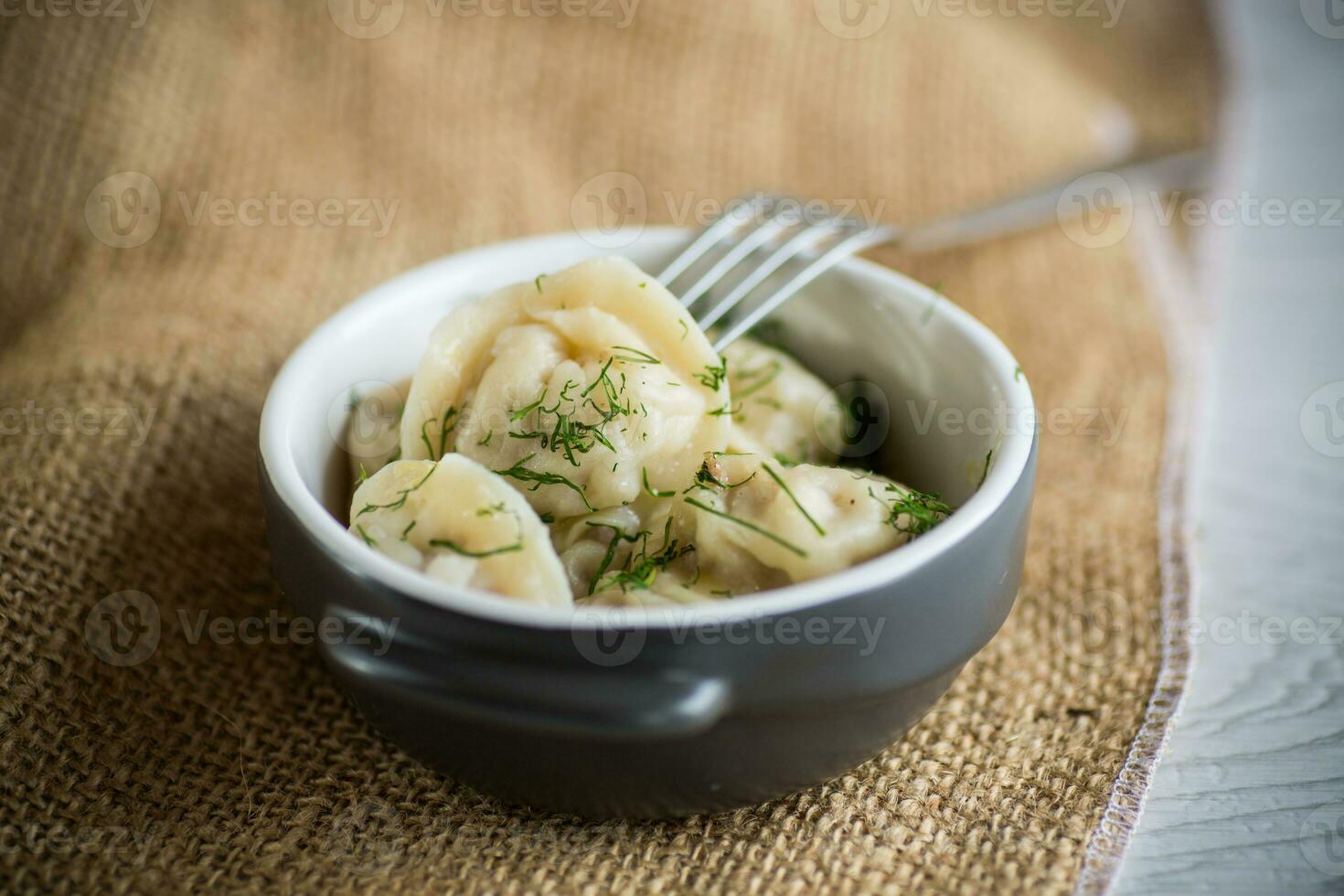 boiled dumplings with meat filling in a bowl photo