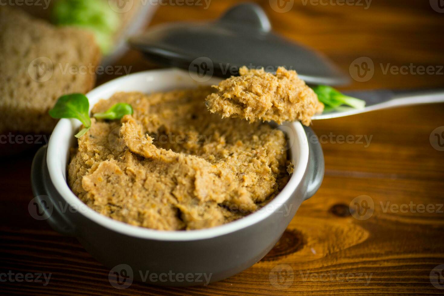 homemade meat pate in a ceramic bowl on a wooden table photo